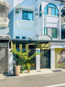 a building with a gate in front of it at Flower House in Tainan