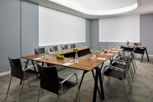 a conference room with long tables and chairs at NH Lisboa Campo Grande in Lisbon