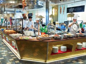 a group of chefs preparing food in a restaurant kitchen at Hotel Universal Port in Osaka