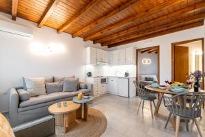 a living room with a couch and a table at Caruana Living in Agia Anna Naxos