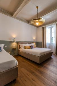 Postel nebo postele na pokoji v ubytování B&B Stanze Guelfe