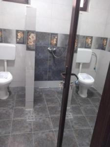 a bathroom with two toilets and a shower at The sweet house! in Vama Veche
