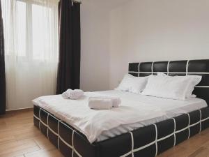 a large bed with two towels on top of it at The sweet house! in Vama Veche