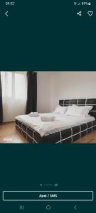 a bed with white sheets and pillows in a room at The sweet house! in Vama Veche