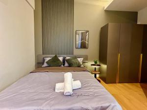 a bedroom with a bed with towels on it at KL Central 33rd Floor KLCC view in Kuala Lumpur