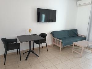 a living room with a table and a couch at Georgia Hotel Apartments in Protaras