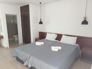 a bedroom with a bed with two towels on it at Georgia Hotel Apartments in Protaras