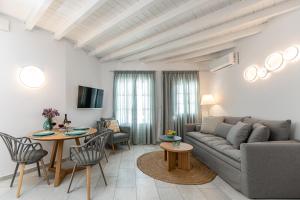 a living room with a couch and a table at Caruana Living in Agia Anna Naxos