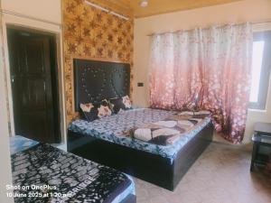 a bedroom with two beds and a window at HOTEl momin in Srinagar