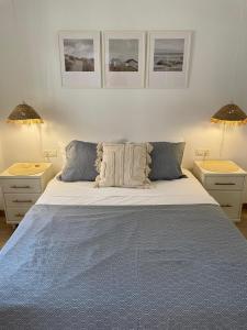 a bedroom with a large bed with two night stands at Torremar Sun and Sea in Torremolinos +9 photos