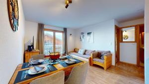a living room with a table and a couch at Pracondu 2 302 - OUTDOOR & FUN apartment 4 pers in Nendaz