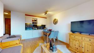 a living room with a large flat screen tv at Pracondu 2 302 - OUTDOOR & FUN apartment 4 pers in Nendaz