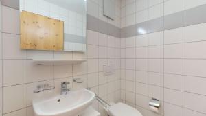 a white bathroom with a sink and a toilet at Pracondu 2 302 - OUTDOOR & FUN apartment 4 pers in Nendaz +5 photos