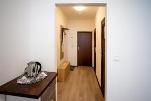 a kitchen with a coffee maker on a kitchen counter at Apartmány Stdaniela in Bohumín