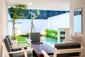 Un comedor con una mesa y dos sillas. en Artha Villa Pererenan By Fays Hospitality, en Canggu