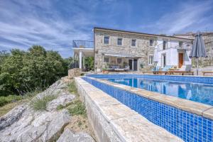 a swimming pool in front of a house at Casa Emilia in Sveti Donat in Buzet