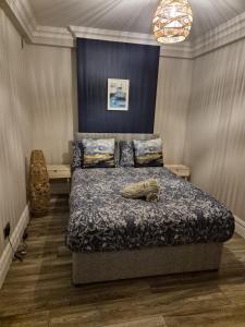 a bedroom with a bed with a blue head board at Ard Na Gaoithe Rossnowlagh Beach in Donegal