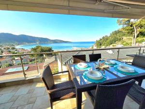 a table on a balcony with a view of the ocean at Golden Sea View -Thasos House in Skala Potamias