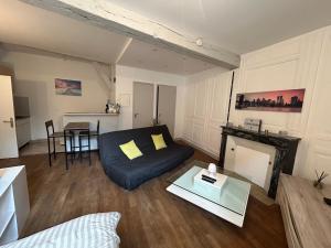 a living room with a couch and a table at 32 Centre ville - Drouaise - 4 couchages in Chartres