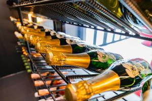 a row of wine bottles in a wine rack at awaJ Beach Club アワジェイビーチクラブ in Awaji