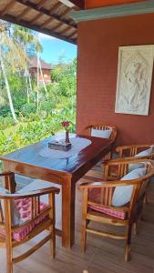 a wooden table and two chairs in a room with a window at Cegeng Lestari Guesthouse in Sidemen +24 photos