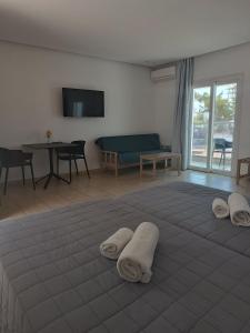 a room with a large bed with towels on it at Georgia Hotel Apartments in Protaras