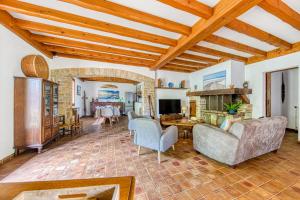a living room filled with furniture and a stone fireplace at Maison de vacances Valériane in Lège-Cap-Ferret