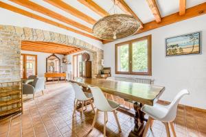 a dining room with a large wooden table and chairs at Maison de vacances Valériane in Lège-Cap-Ferret +20 photos