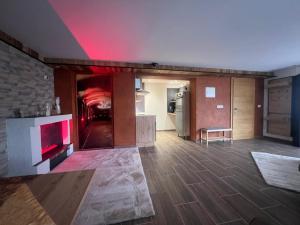 a large living room with a fireplace and a kitchen at Apart-Bergheim in Fliess