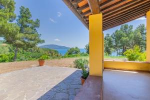 an outdoor patio with a view of the ocean at Farmhouse by the sea - Grilli 3 in Lacona