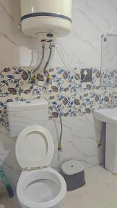 a bathroom with a toilet and a sink at HOTEl momin in Srinagar