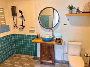 a bathroom with a sink and a mirror and a toilet at Turtle Beach House TWO 