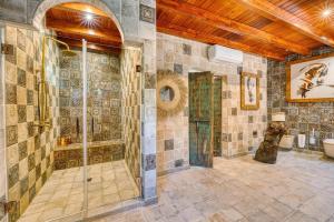 a tiled bathroom with a shower and a toilet at Cortijo Boutique Marbella in Marbella