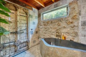 a bathroom with a large tub and a window at Cortijo Boutique Marbella in Marbella