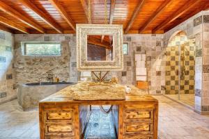 a bathroom with a large sink and a tub at Cortijo Boutique Marbella in Marbella
