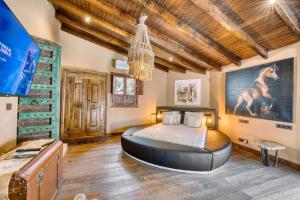 a bedroom with a large bed in a room with wooden ceilings at Cortijo Boutique Marbella in Marbella