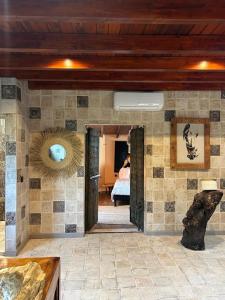 a room with a stone wall with a woman in a bed at Cortijo Boutique Marbella in Marbella