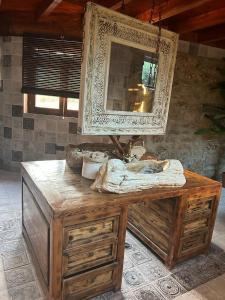 a wooden dresser with a mirror on top of it at Cortijo Boutique Marbella in Marbella