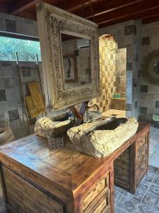 a bathroom with a large stone sink and a mirror at Cortijo Boutique Marbella in Marbella