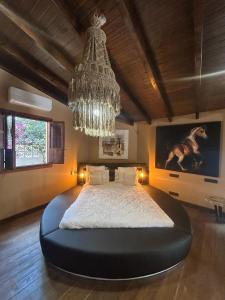 a bedroom with a large bed with a chandelier at Cortijo Boutique Marbella in Marbella