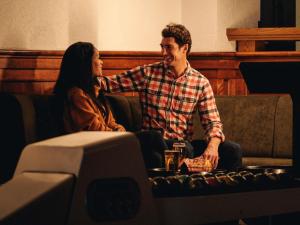 a man and a woman sitting on a couch at Fairmont Banff Springs in Banff