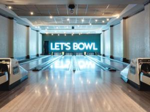 an empty bowling alley with a lighted lets bowl sign at Fairmont Banff Springs in Banff