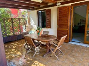 a wooden table and chairs on a patio at Villa Stintino in Stintino