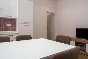 a white table and chairs in a room at Casa degli Oleandri in Giardini Naxos +68 photos
