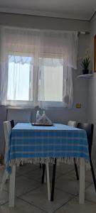 a blue and white table in a room with two windows at Big,Smart & Comfort ! in Kalamata