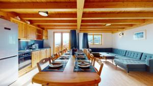 a dining room with a long table and a couch at Pracondu 2 502 - OUTDOOR & FUN charming apartment in Nendaz