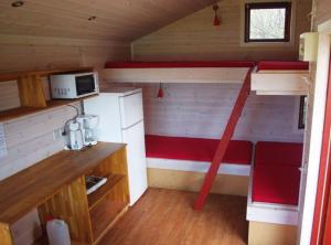 a tiny house with a kitchen and a bunk bed at Ørsted Outdoor in Lille Ladager +7 photos