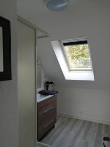 a bathroom with a skylight and a sink and a window at Villa Jozefina résidence les Oyats in Jullouville-les-Pins