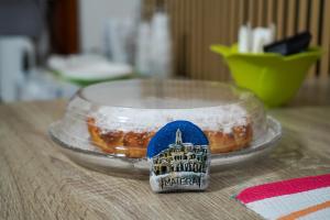 a glass lid with a pastry on a table at B&B La Dimora di Rosa in Matera +62 photos