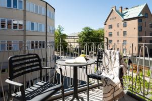 a patio with a table and chairs on a balcony at Sky Hotel City Apartments in Linköping